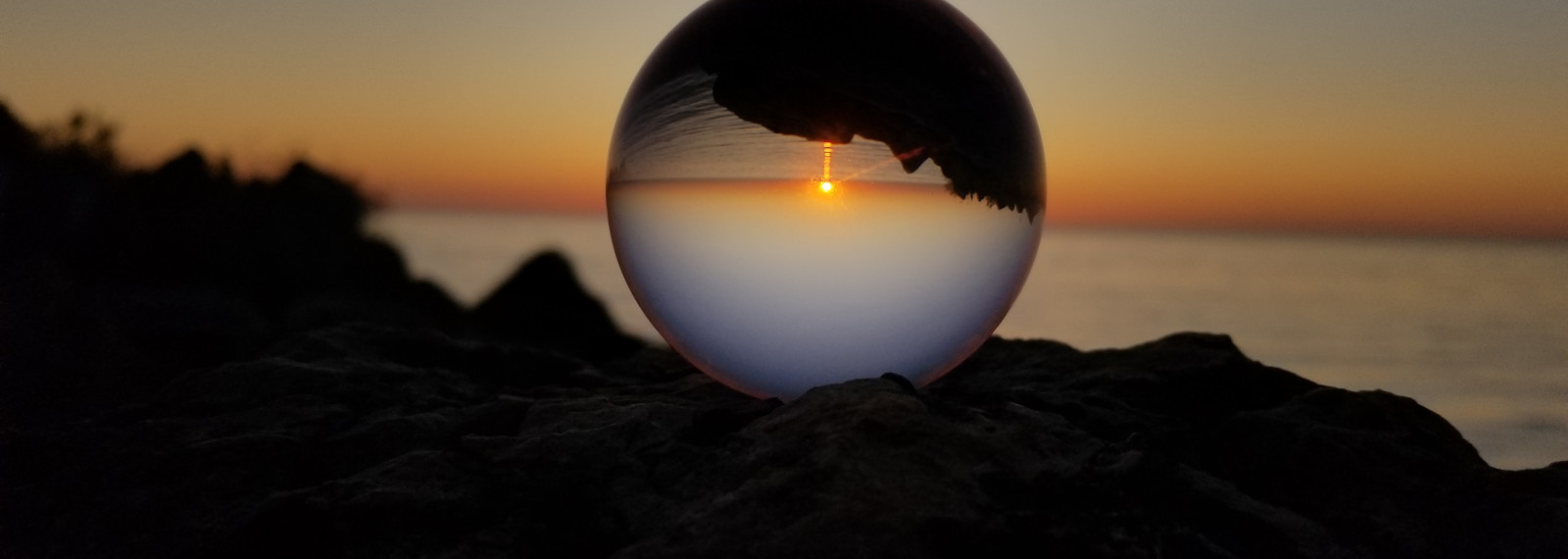 Image looking through a transparent sphere to a sunset