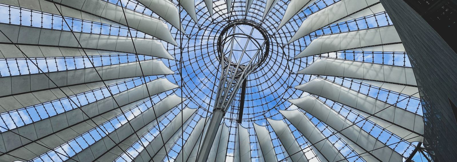 Image looking up into the inside of a circular glass structure