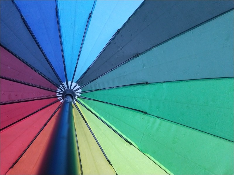 Image looking up to the hub of a colourful umbrella