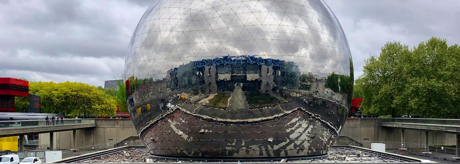 Image looking through a giant transparent sphere to a city scape