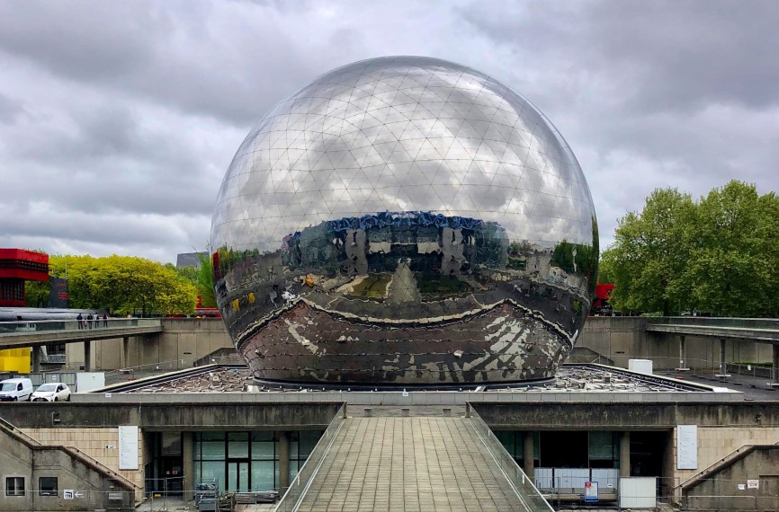 Image looking through a giant transparent sphere to a city scape