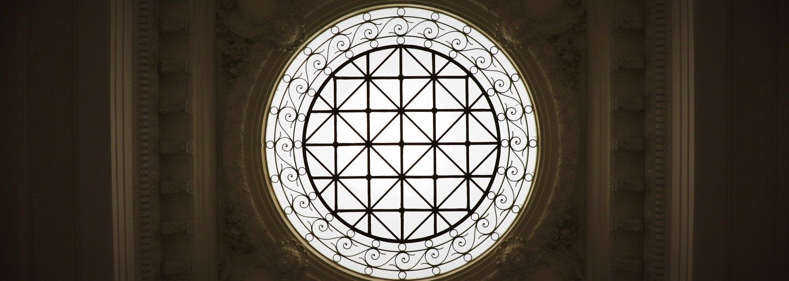 Looking up through a circular window in a roof