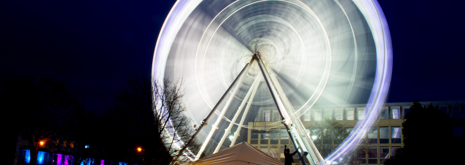 Image of an illuminated Ferris wheel in a night scene