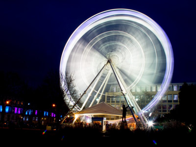 Image of an illuminated Ferris wheel in a night scene