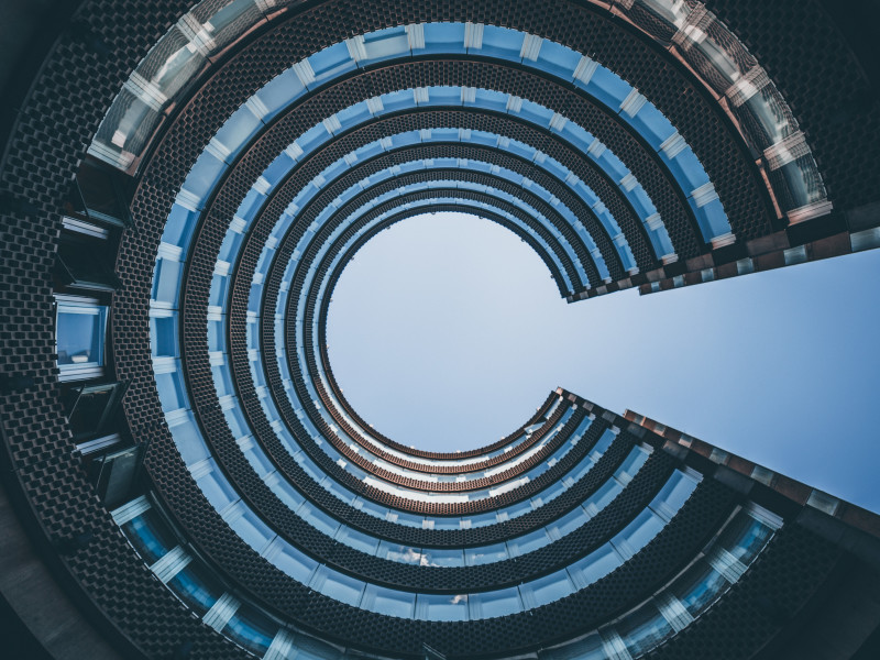 Image looking up at the sky through a circular building