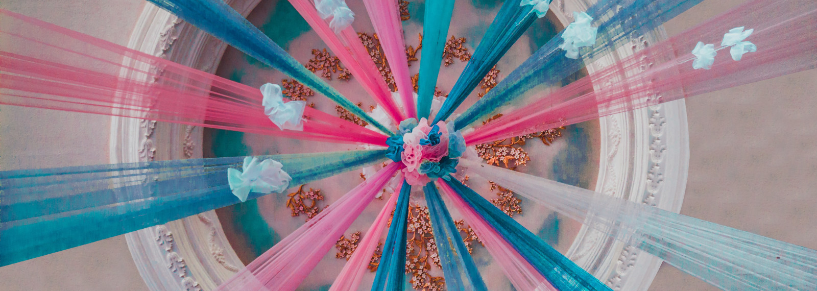 Image of colourful cascades descending from an ornate ceiling piece