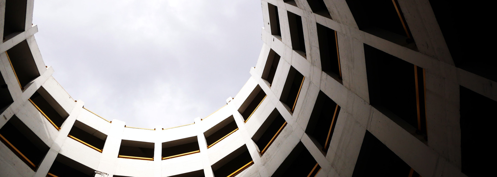 Image looking up at the sky through a circular building