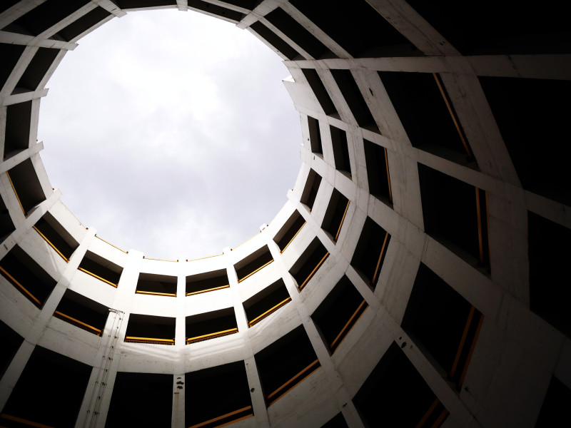 Image looking up at the sky through a circular building