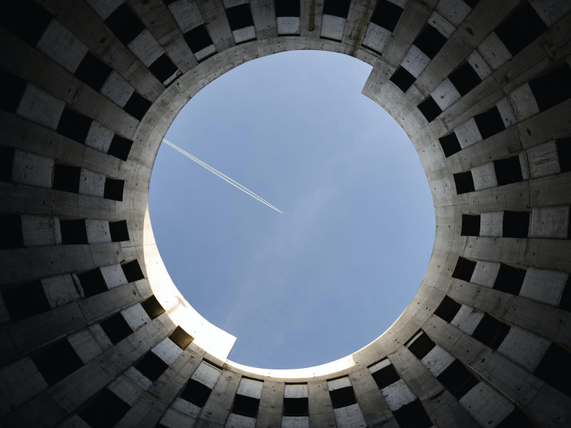 Image looking up to the sky from within a circular building