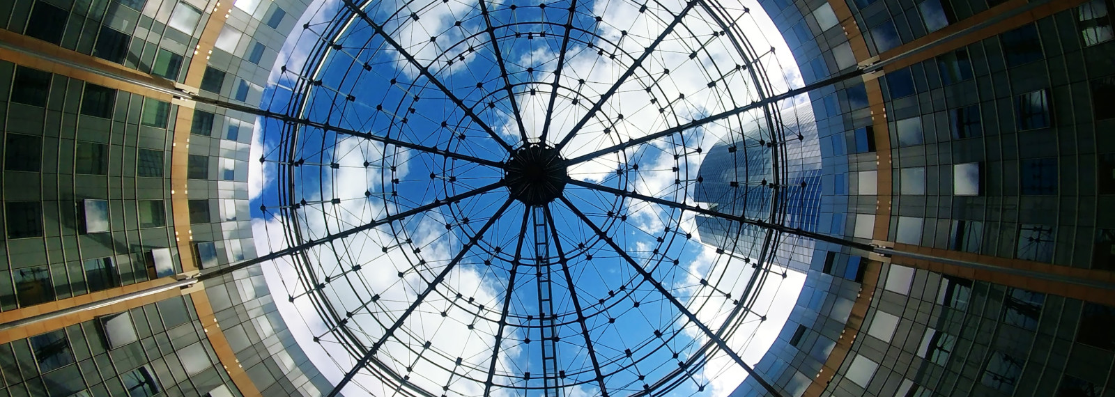 Image looking up at the sky through a circular building
