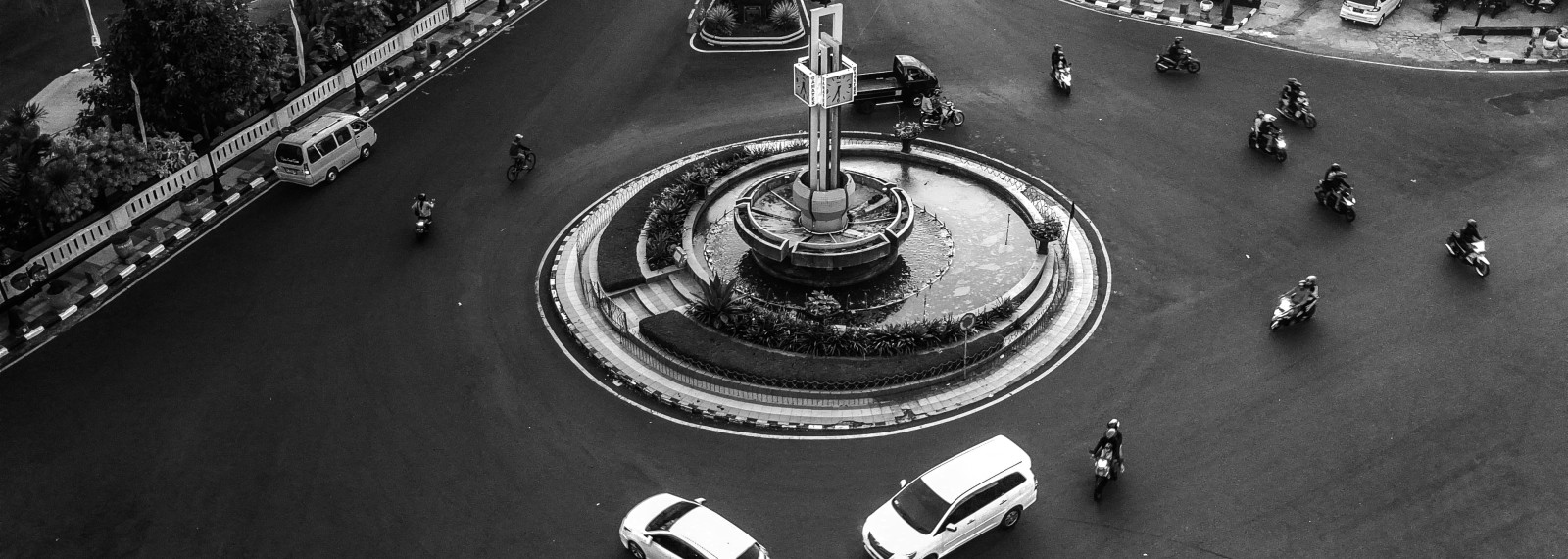 Image looking down at a roundabout with cars and cycles circling