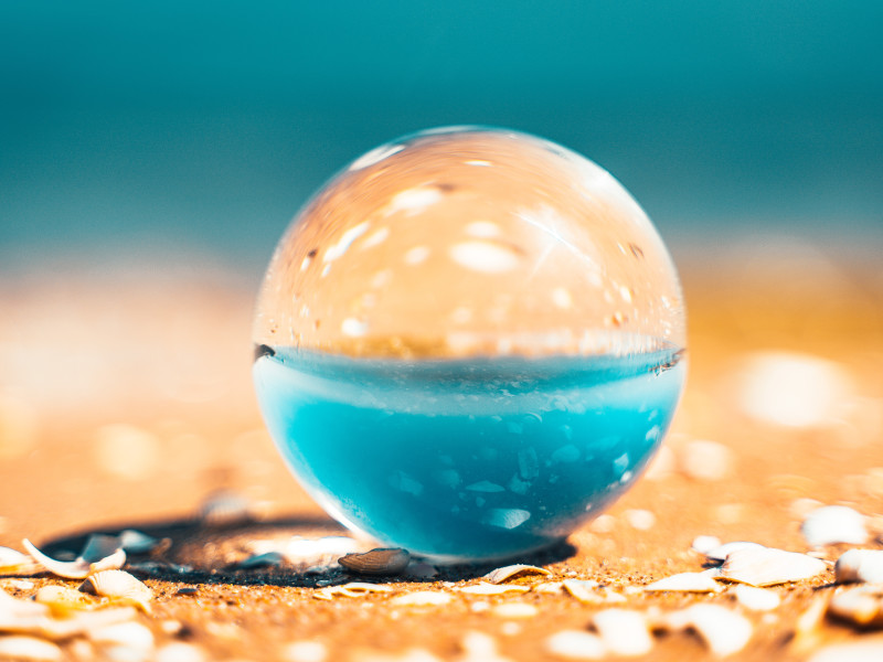 Image of a spherical, transparent object on a beach