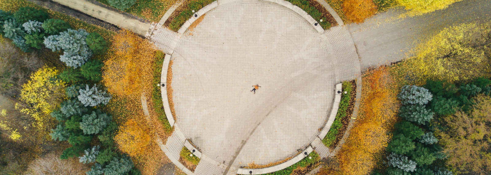Aerial video of a circular structure surrounded by trees