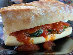 fried zucchini on a bun with tomato sauce