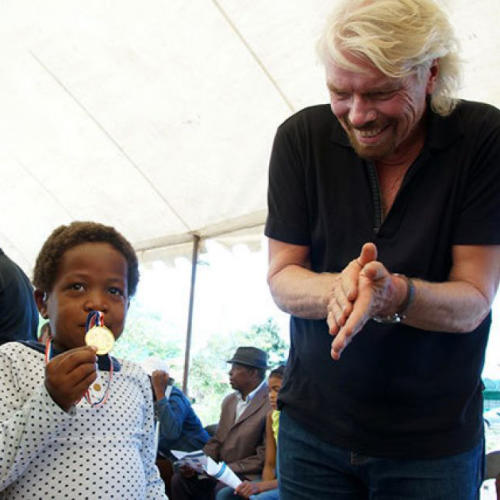 Richard Branson and a child at the Bhubezi health clinic