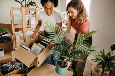 Two women moving into a new home 