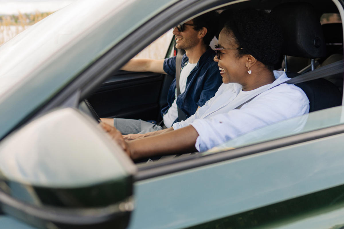 Woman and man driving with the windows down