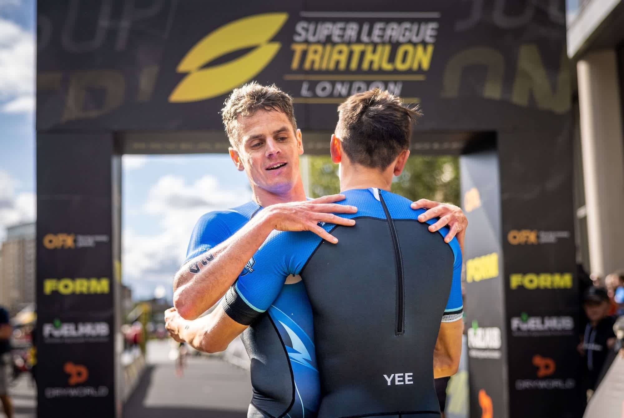 Jonny Brownlee and Alex Yee embracing after supertri London 2023
