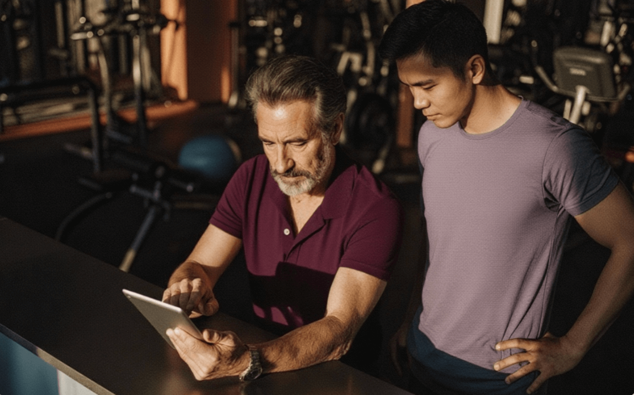 Two people looking at a tablet. 