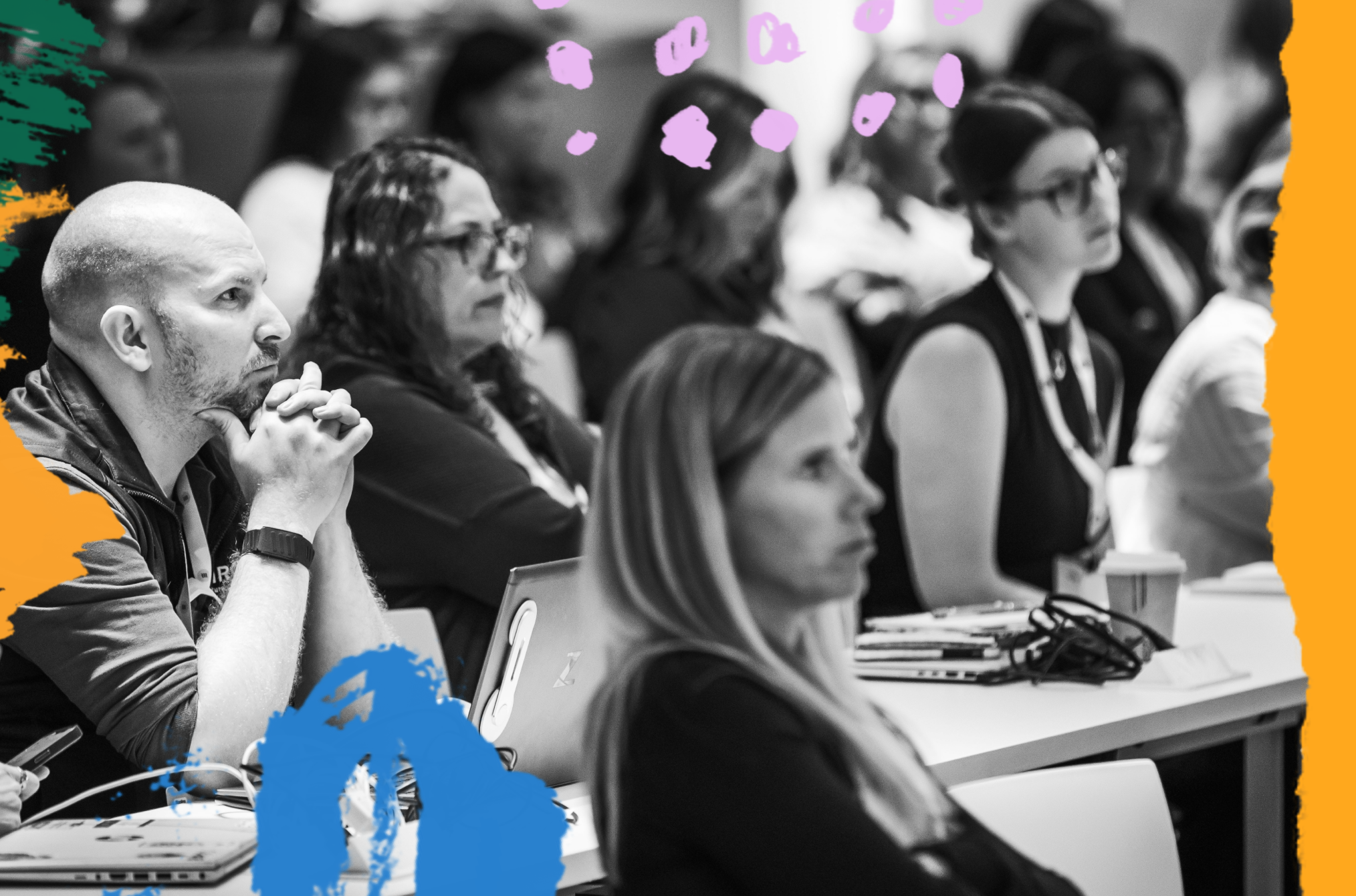 Professionals sitting at a table looking engaged ahead of them