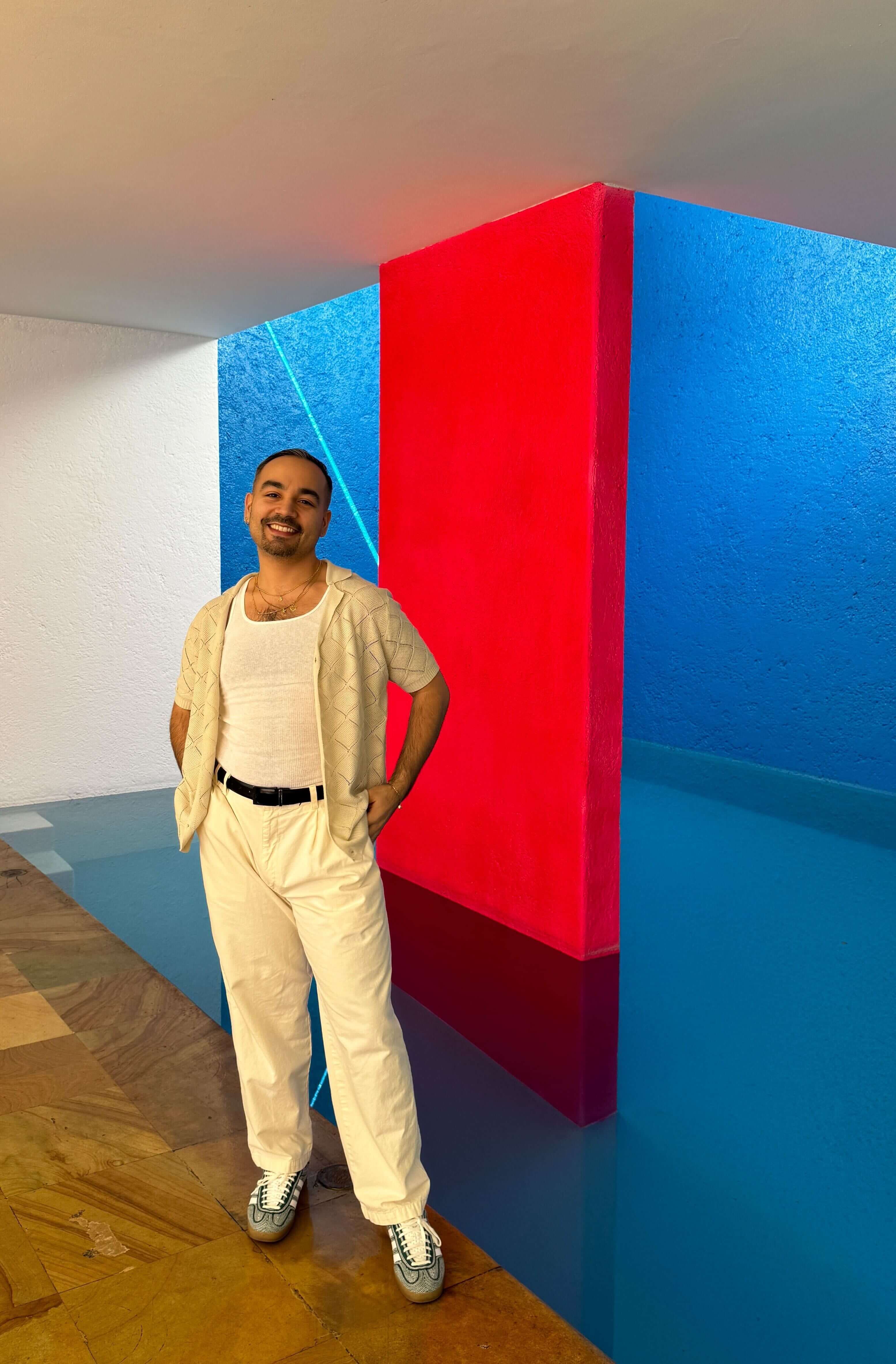 Geovani Montepeque standing against striking architecture. 