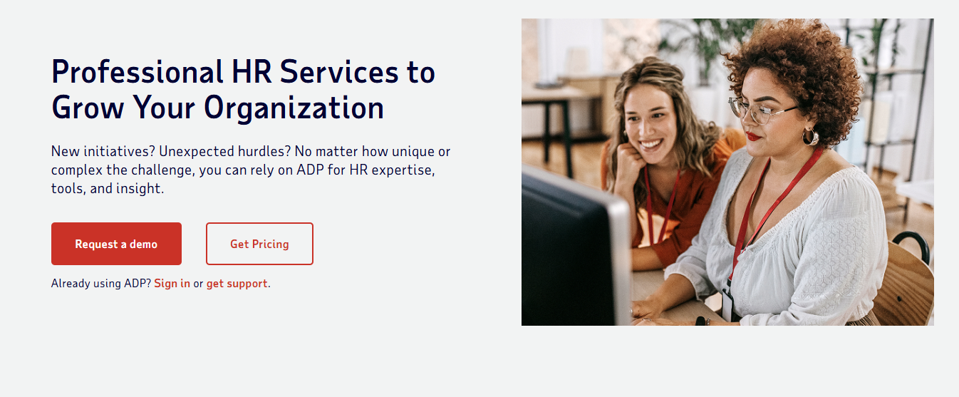 Two professionals with lanyards looking at a computer screen, with ADP HR services promotional text and call-to-action buttons.