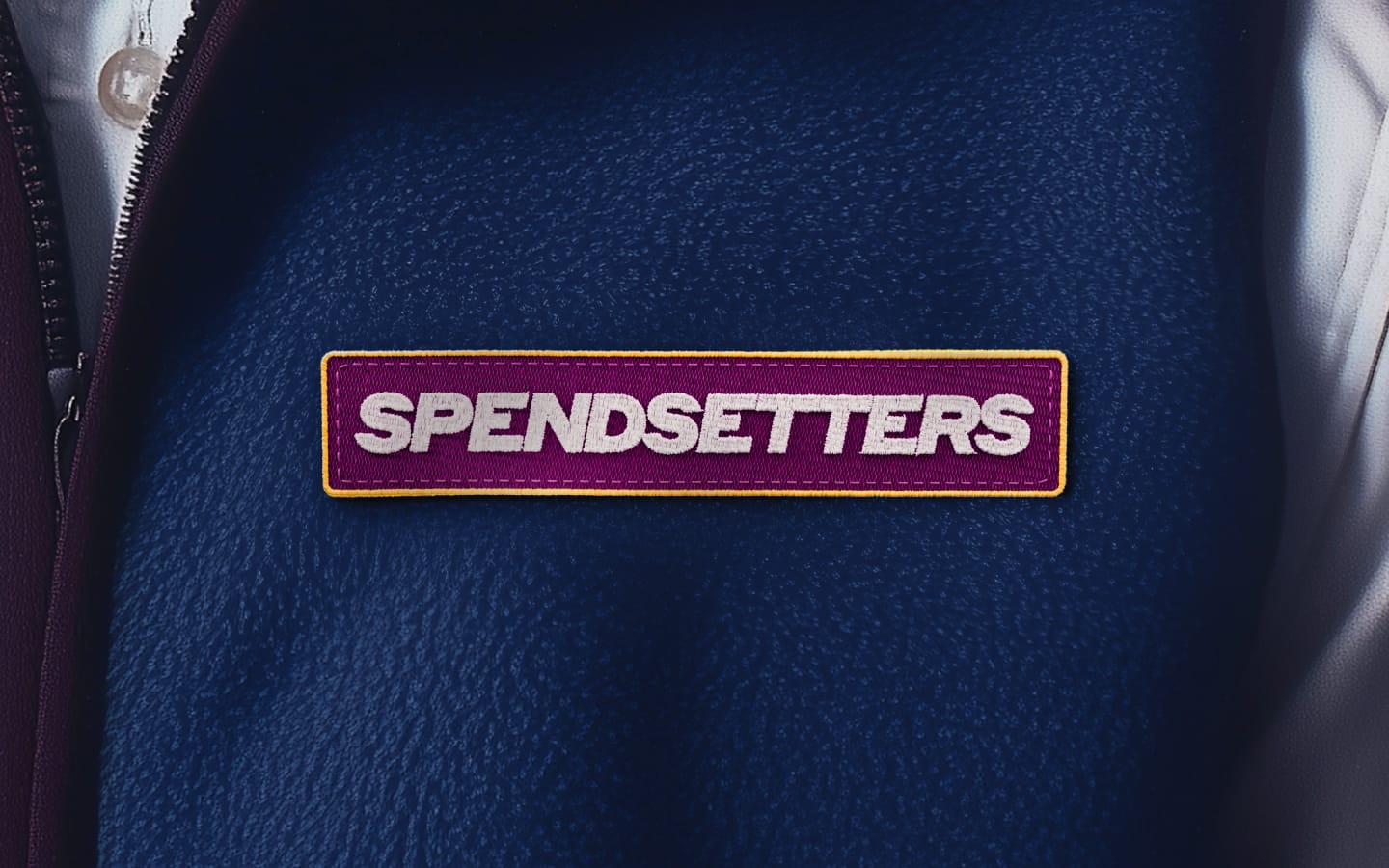 Photorealistic graphic illustration of a person wearning a fleece vest with a logo that says Spendsetters