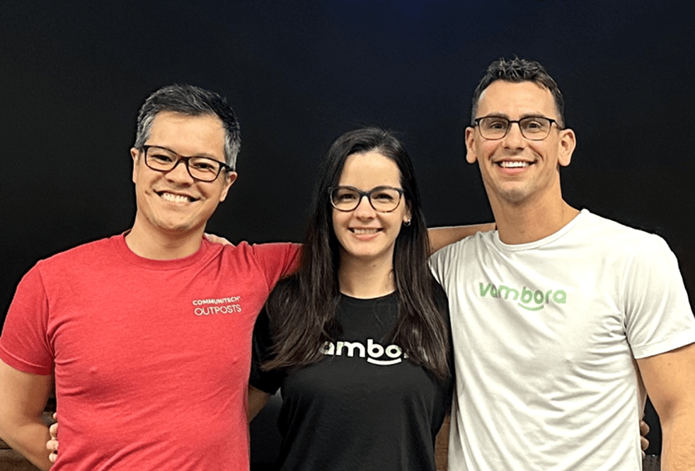 A photograph of three smiling Vambora employees