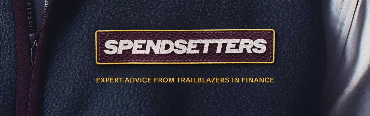 Close up of someone wearing a fleece jacket with a patch that that says, "Spendsetters," with text below that says, "Expert advice from trailblazers in finance." 