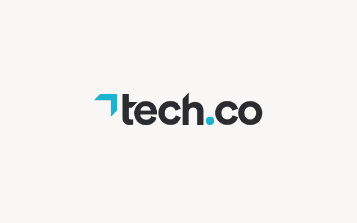 Tech.co logo with black text and teal accent mark on light pink background