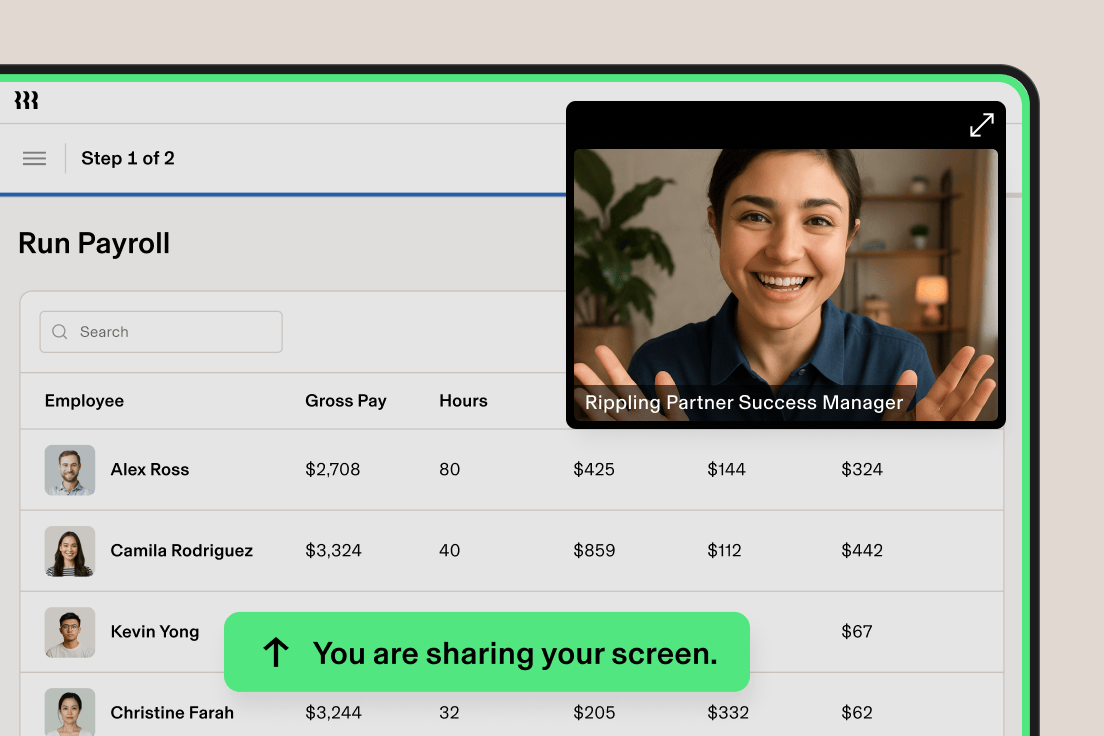 Person with dark curly hair in black shirt gesturing with pen during conversation against wooden background.