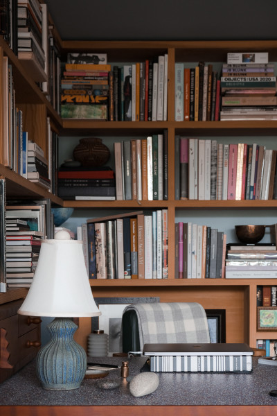 Roman's home office and expansive library with a lamp by Akio Nukaga