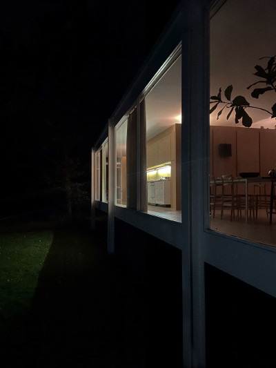 Looking down the length of the Farnsworth House at night.