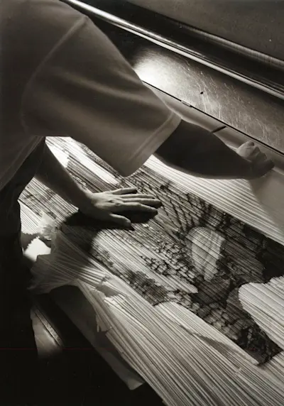 A pleated garment is visible as soon as the top piece of paper is torn and is ready to wear immediately