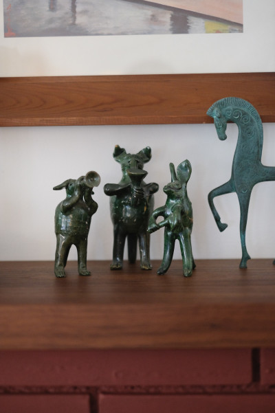 Figurines above fireplace mantle