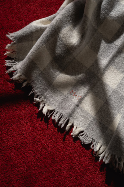 Marina Contro Hand Woven Blanket resting on a red mohair rug that Josie made with Gregory Parkinson.