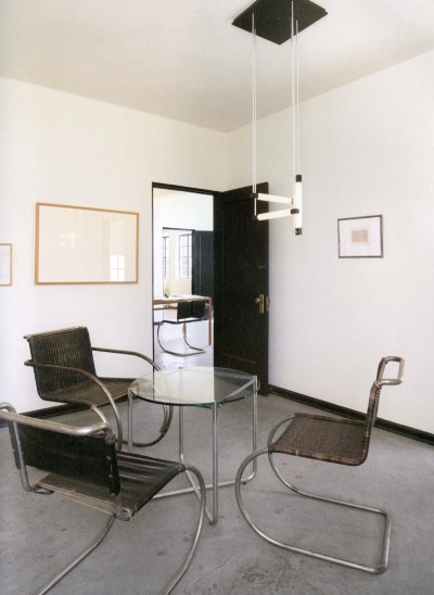 View of interior with table and chairs by Mies van der Rohe; lamp by Gerrit Rietveld. Photo 2018.
