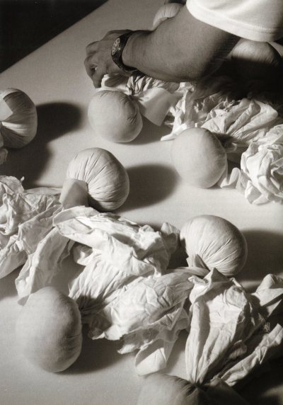Balls of cut garment in the "pleat and crush" process. They are wound into a ball after pleating. 