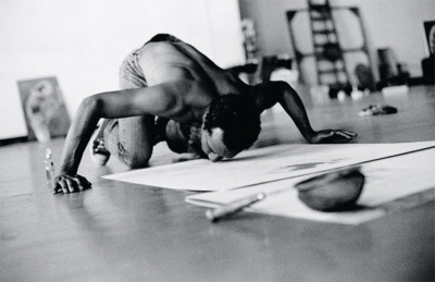 David Hammons making a body print in his Slauson Avenue studio, Los Angeles, 1974. Photo by Bruce W. Talamon; Artforum