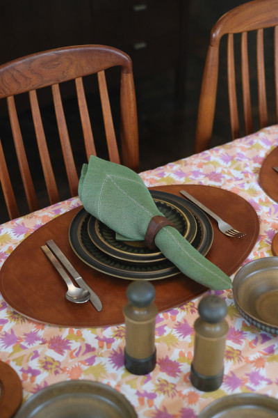 Table spread with Studio Ford Cactus Flower Tablecloth, Peter Speliopoulos for Commune Leather Placemats, Napkins, and The Long Confidence Napkin Rings