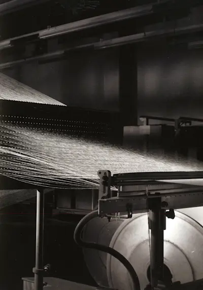 The sight of several hundred threads being coformed to a uniform tension and spooled onto beams (off camera)