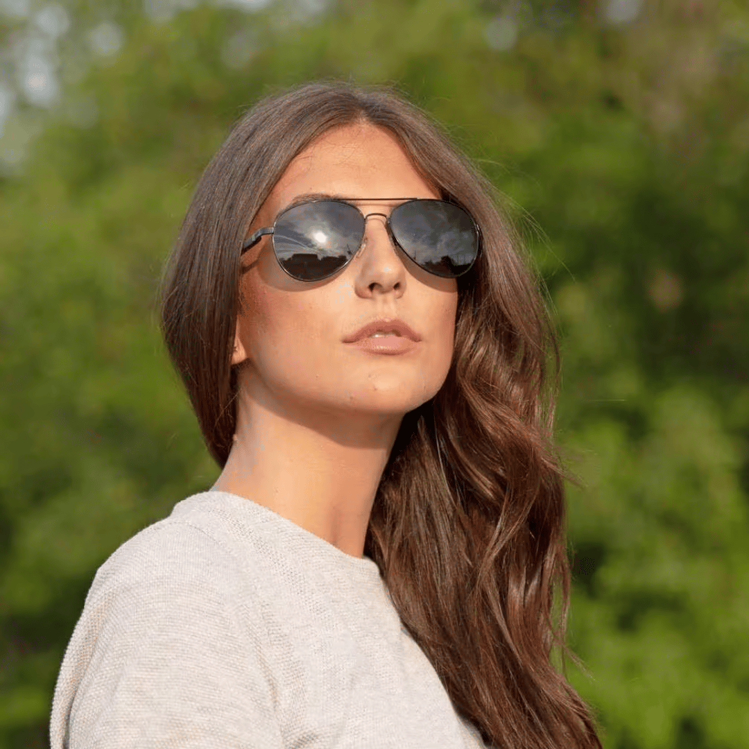 Person with oval face shape experimenting with hairstyles and eyewear. 