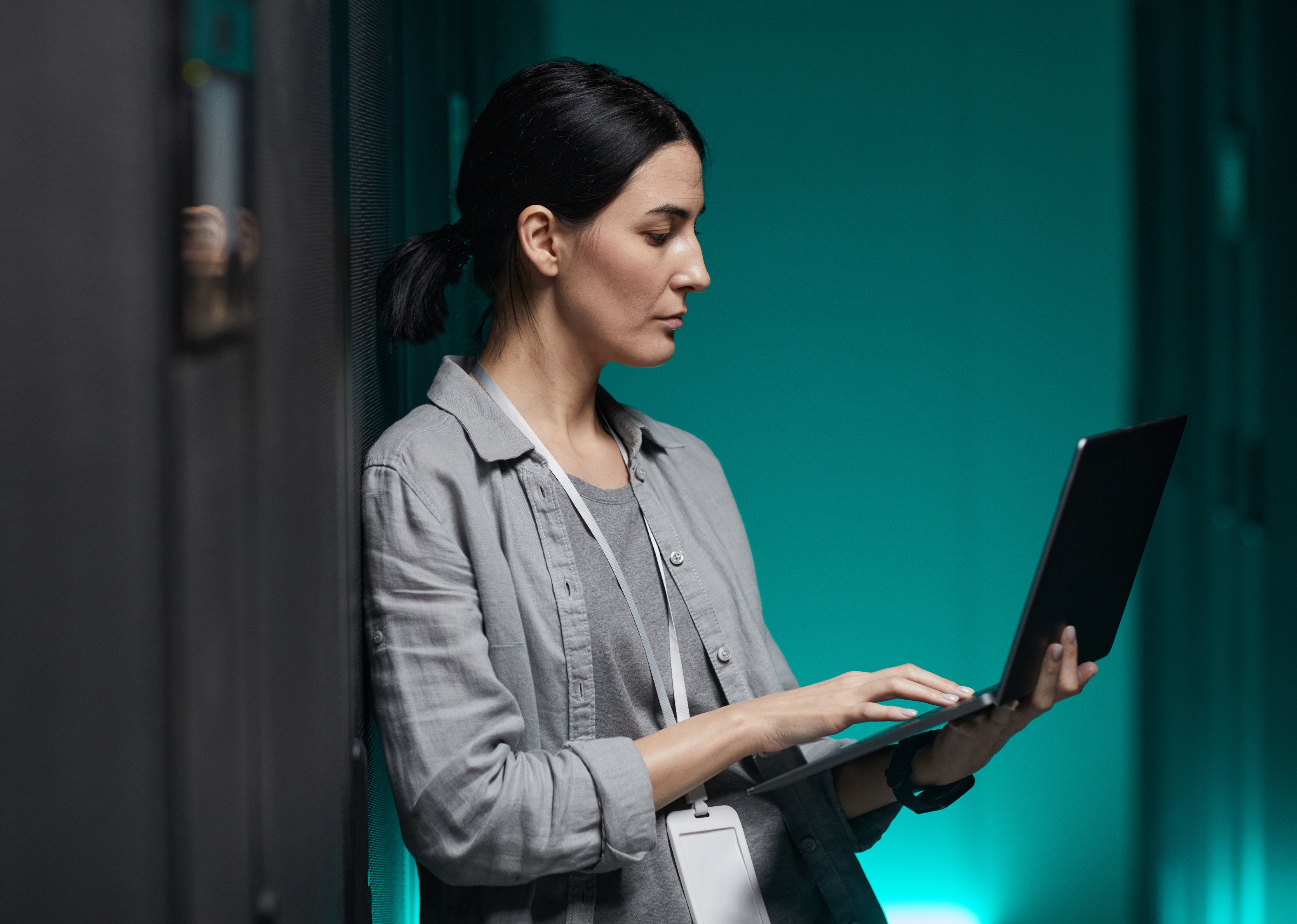 Data quality, Storage & Curation - woman holding laptop in a computer server room