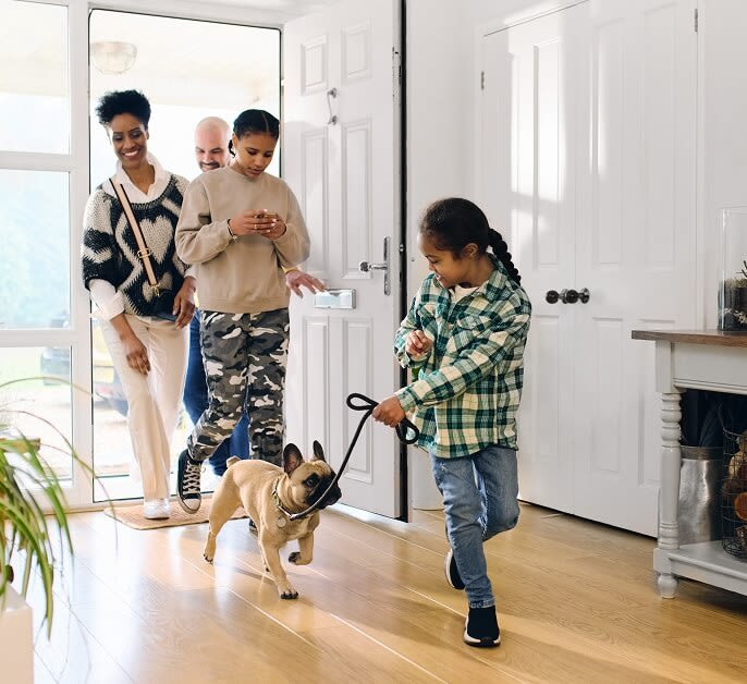  Family entering home safely with Weiser HomeConnect620 providing secure Grade 2 certified protection