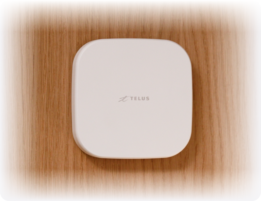 A SmartHome+ Hub mounted on a wooden wall.