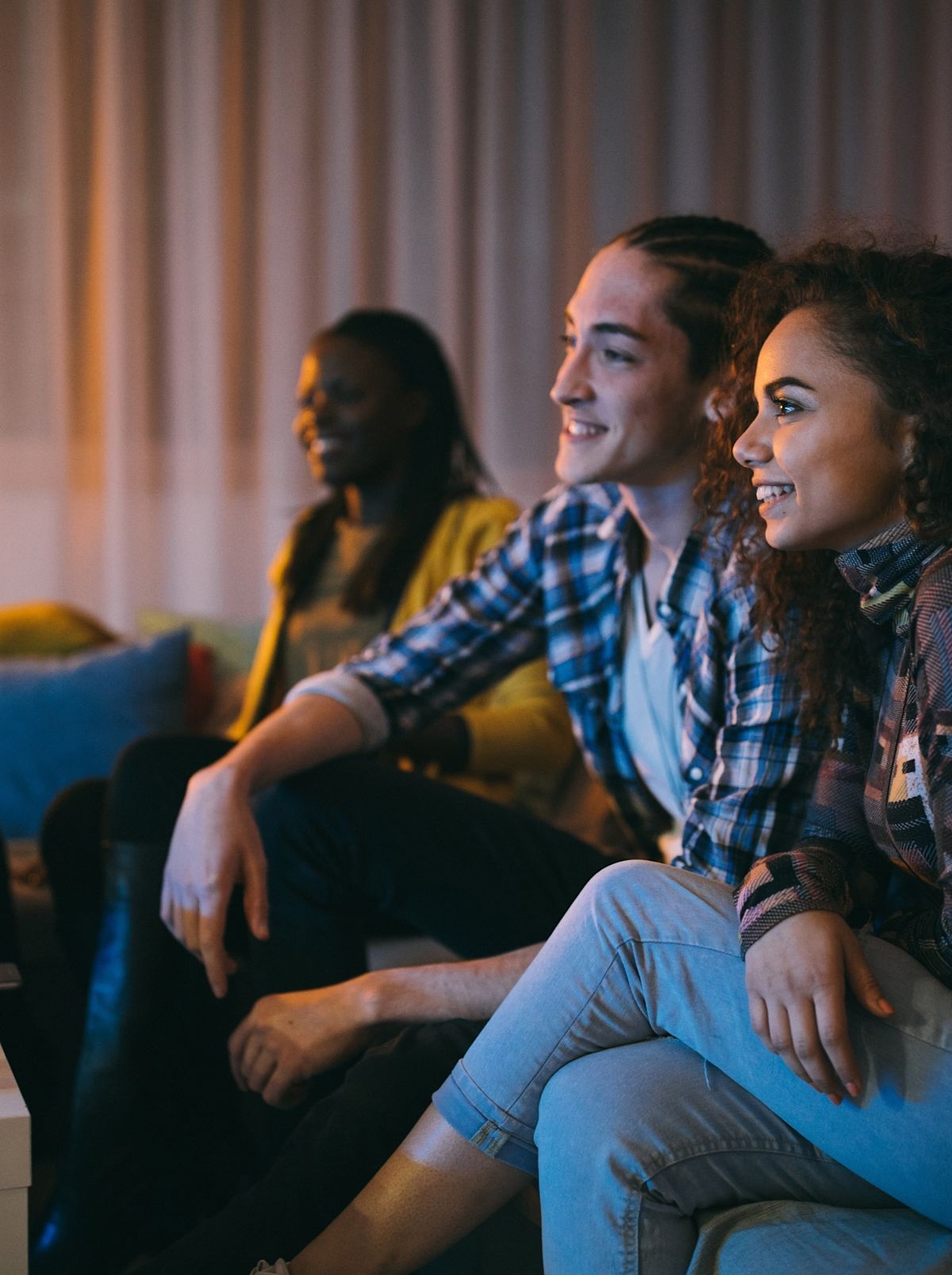 A group of people watching TV using the TELUS TV Mini.