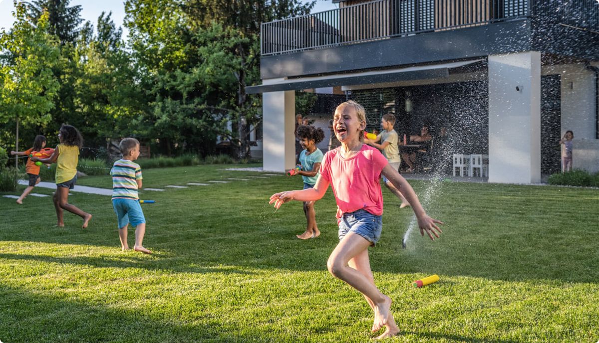A TELUS Outdoor Camera shows a family playing in the backyard.