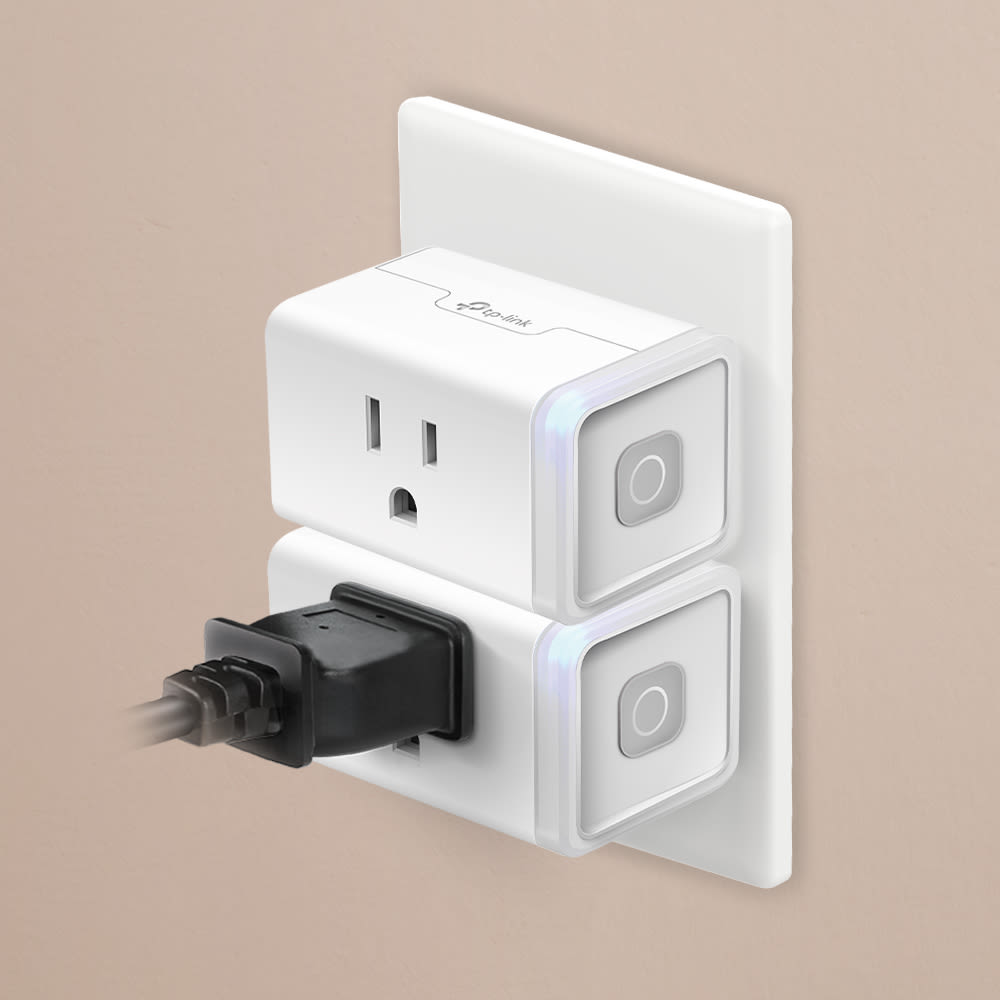 Two Kasa Smart Plug Minis stacked in a dual outlet, showing compact design that leaves space for a second plug.