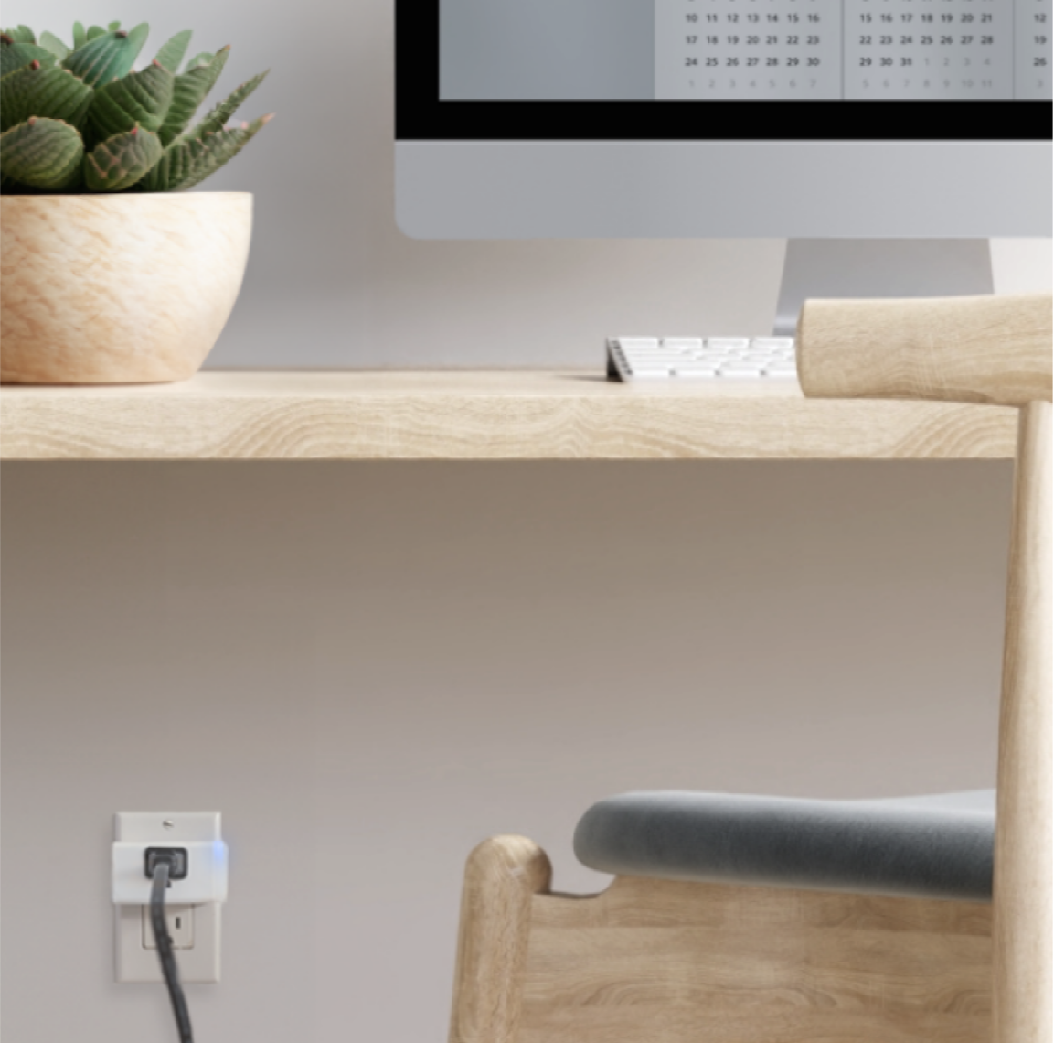 A home office computer is plugged in to a smart plug.