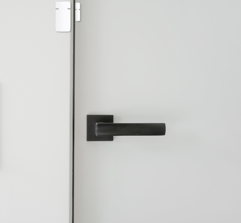 Lifestyle shot of a Kasa Smart Plug Mini plugged into a wall, with a humidifier plugged into it.